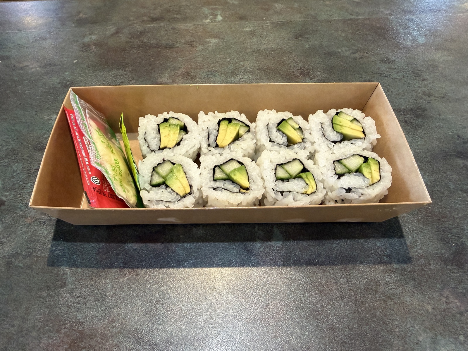 Avocado rolls in a takeout box