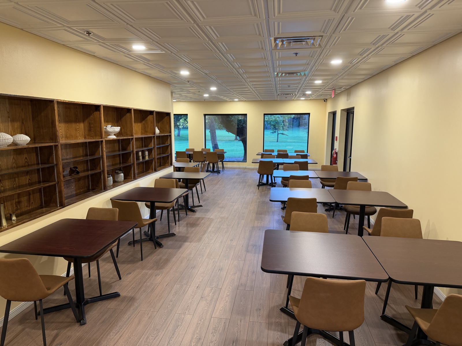 The new dining room with tables and windows overlooking the course